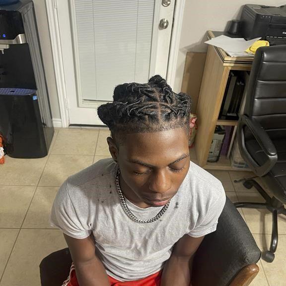 A Black student was suspended for his hairstyle. Now his family is suing Texas officials